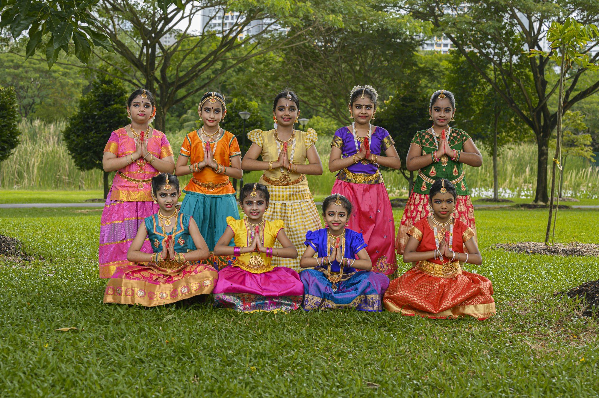 The full group of students posing together in costume
