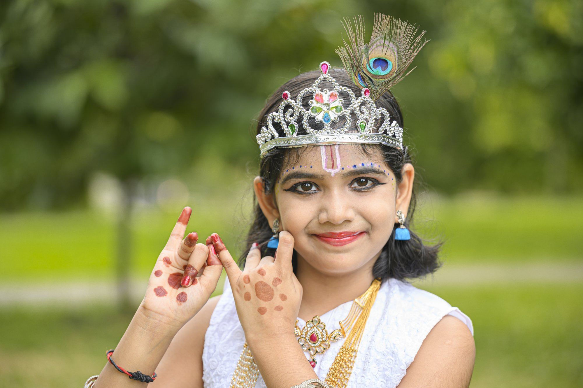 A student dressed as Krishna with a peacock-feather crown