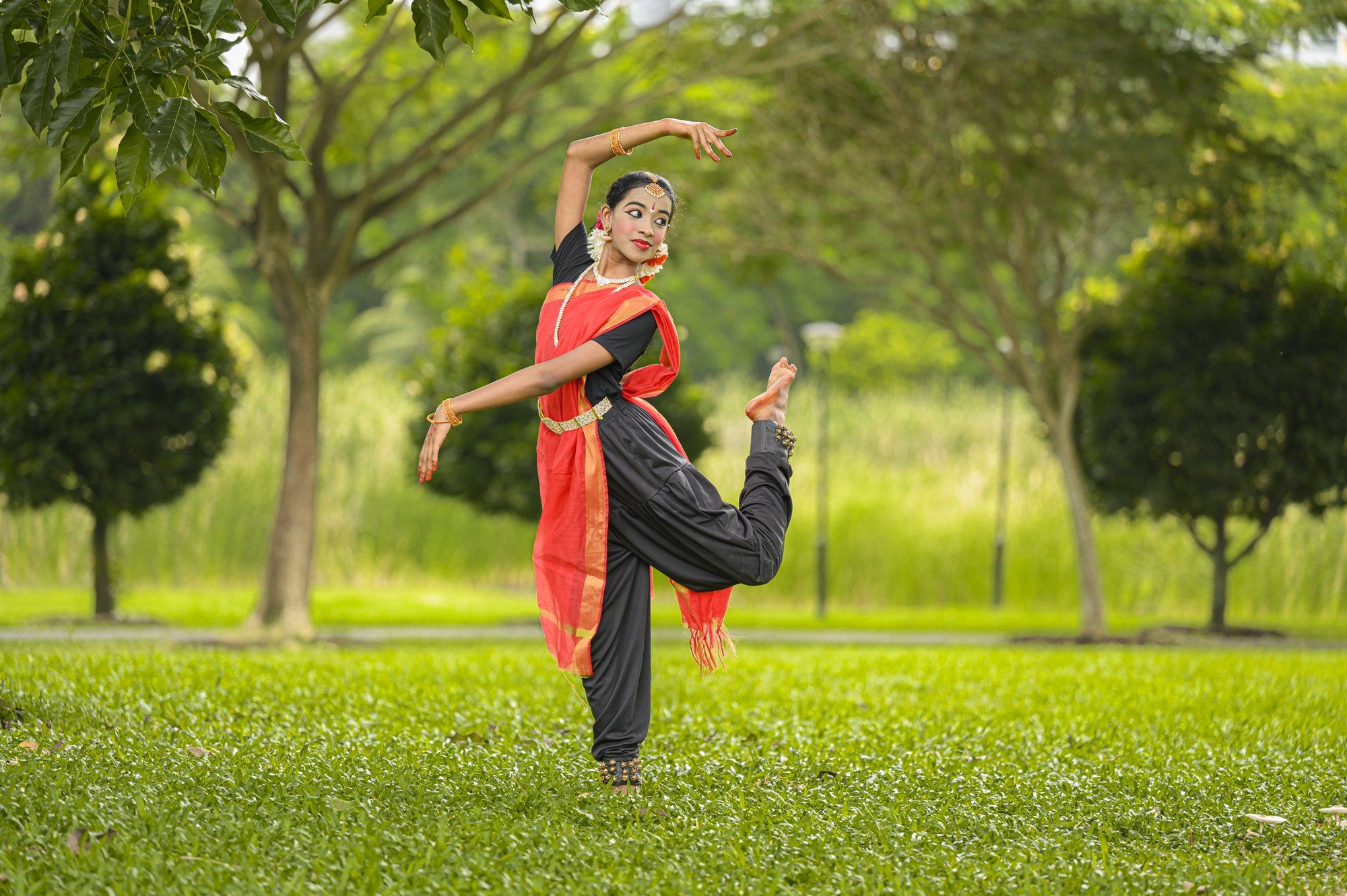 A senior student with one leg raised behind
