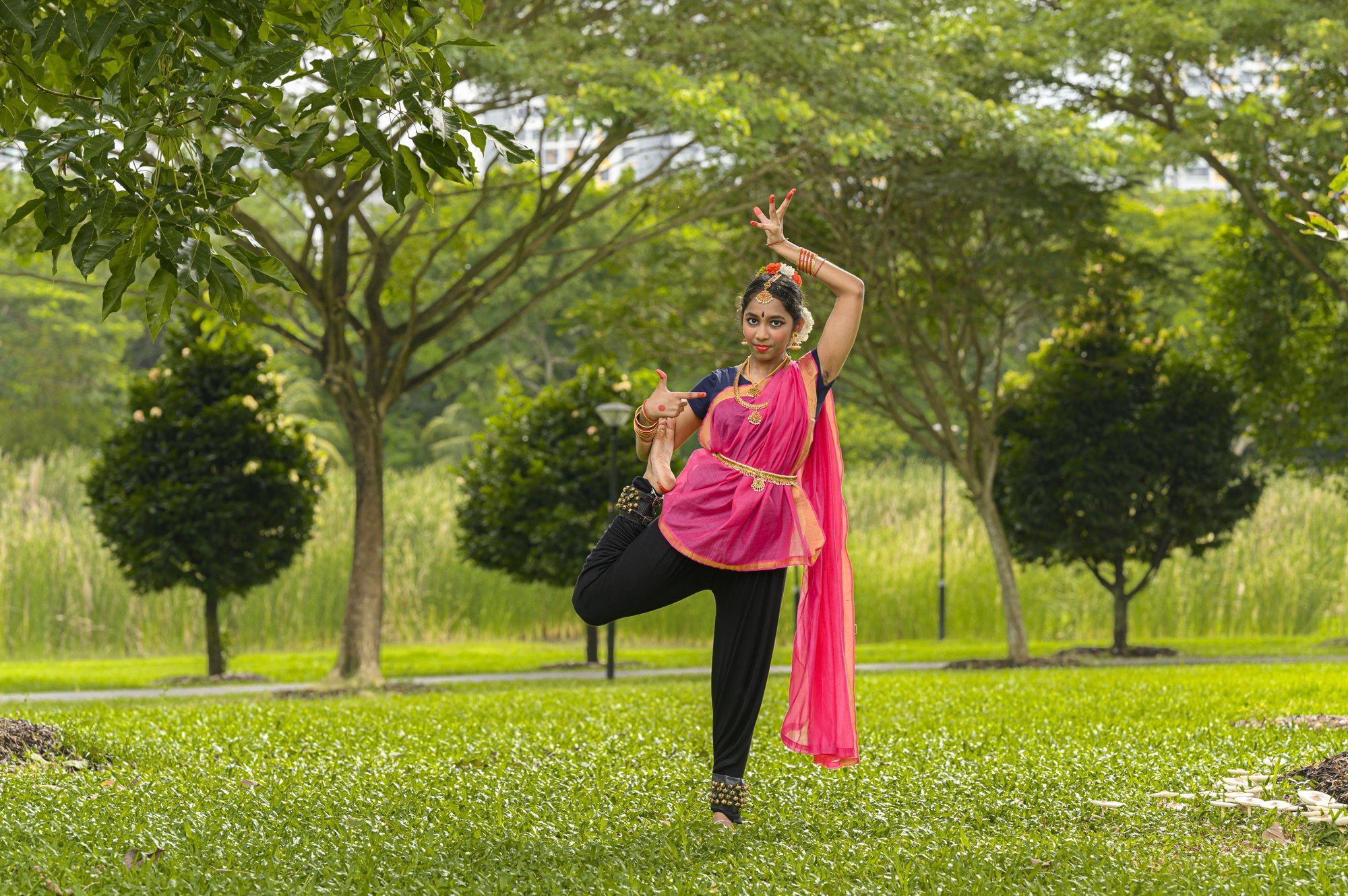 A senior student balancing on one leg