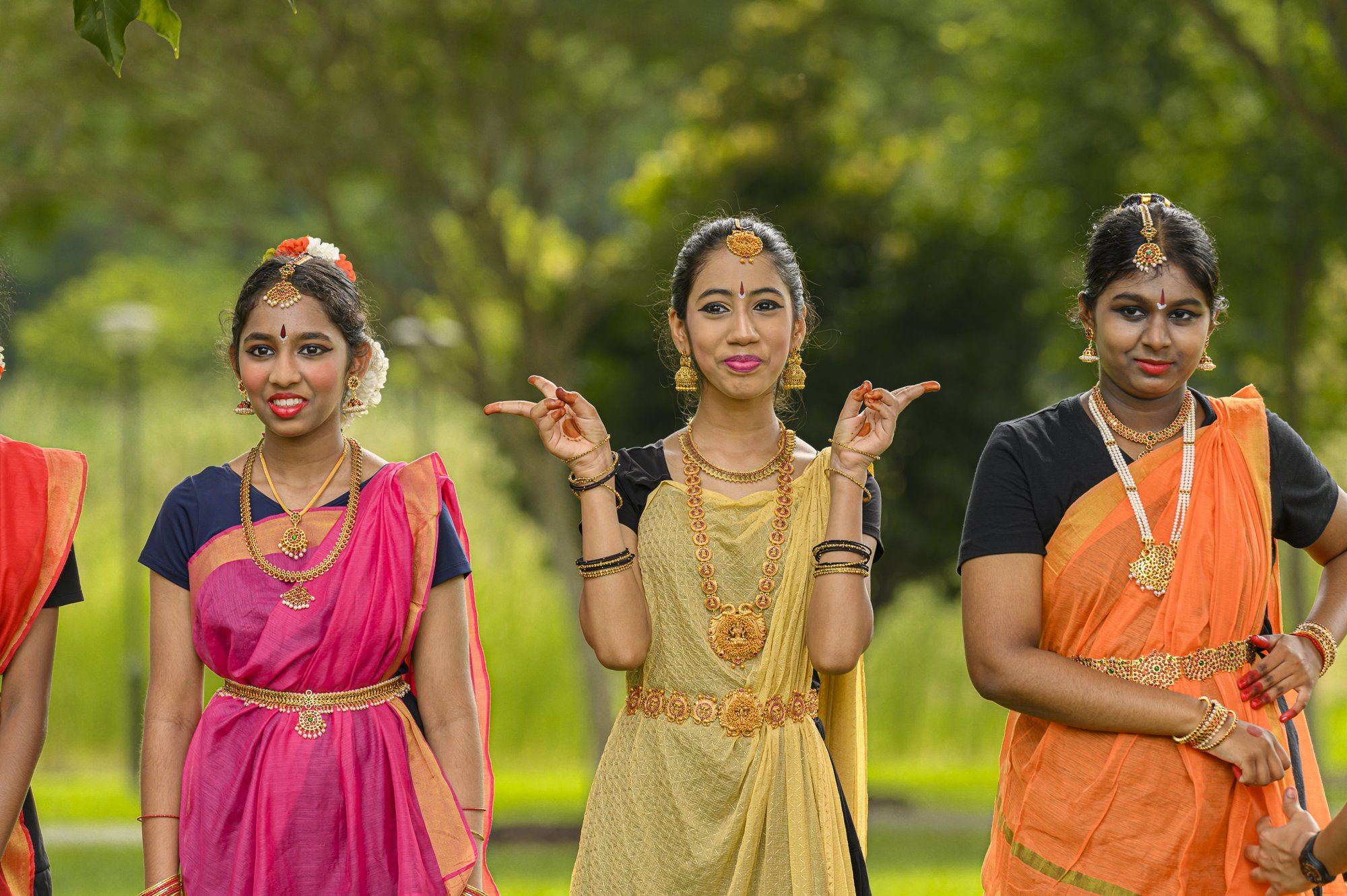 Senior students in costume showing mudras