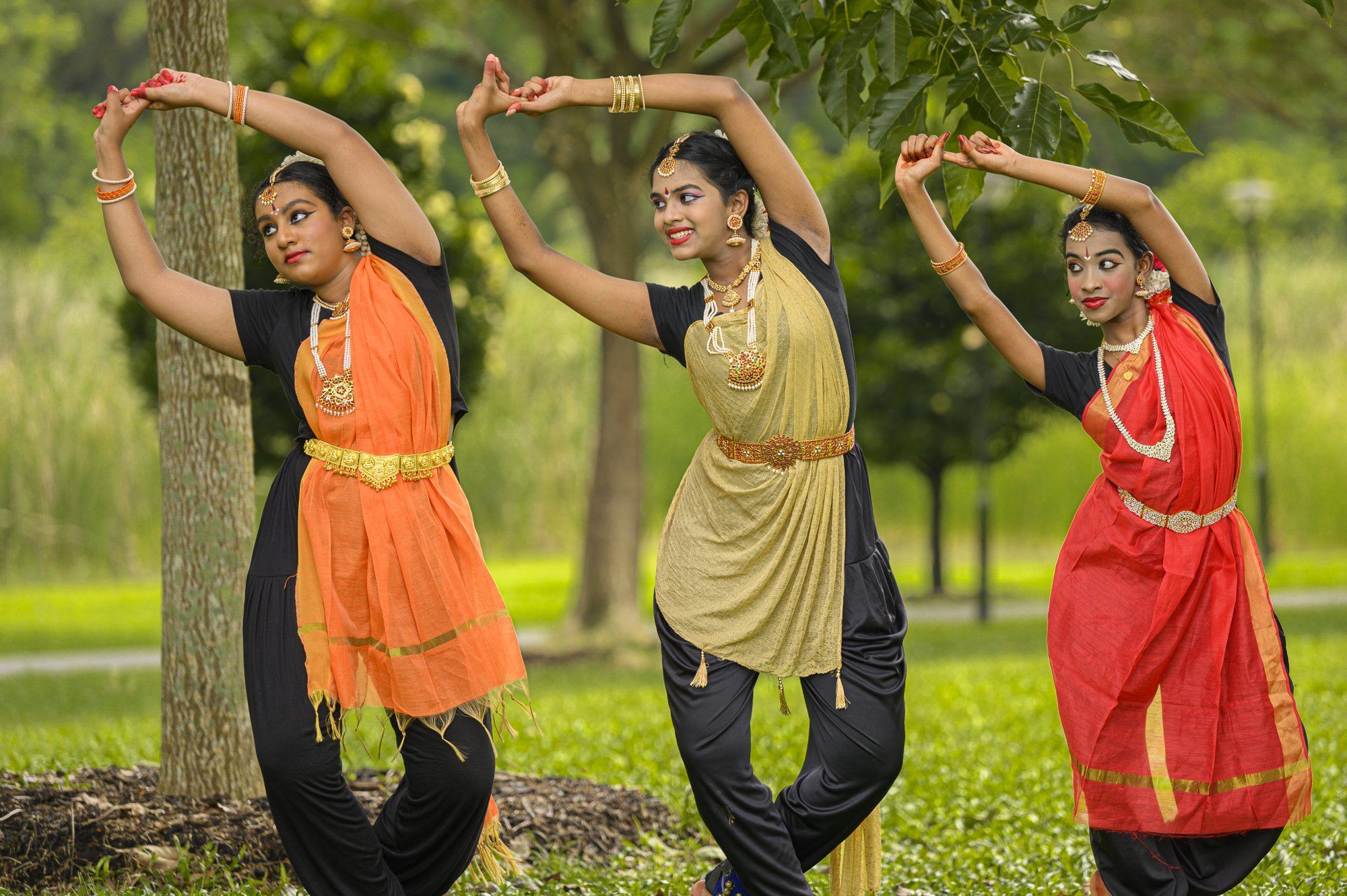 Three senior students in the same pose in unison